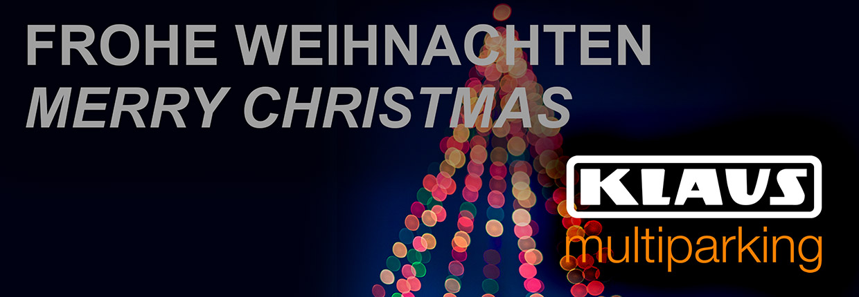 Merry Christmas in front of an illuminated Christmas tree, bottom left logo KLAUS Multiparking